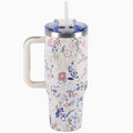 Floral-patterned tumbler with handle and straw on a white background