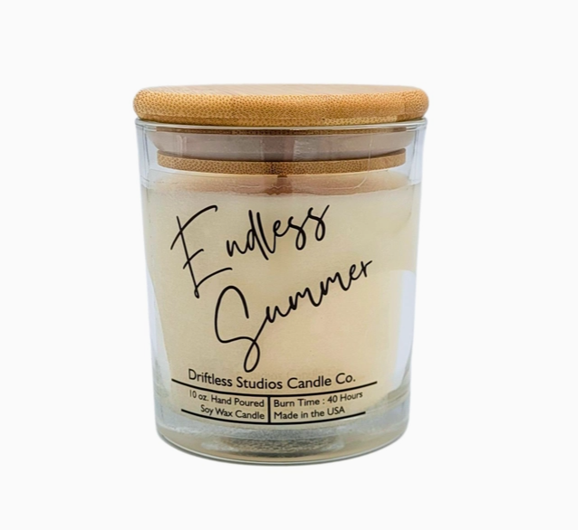 Endless Summer scented candle in a clear glass jar with bamboo lid, on a white background.