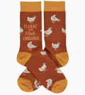 Pair of orange novelty socks featuring chicken designs and phrase    "fluent in fowl language," on a white background.