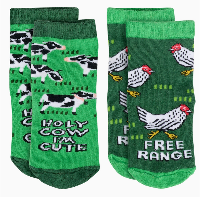 Two pairs of green baby socks featuring farm themes, on a white background.