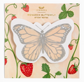 Butterfly-shaped sticky notes featuring a monarch butterfly design in orange, black, and white on a white backing, set against a decorative background with strawberries and green leaves.