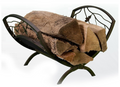 Wooden logs in a decorative metal firewood holder on a white background