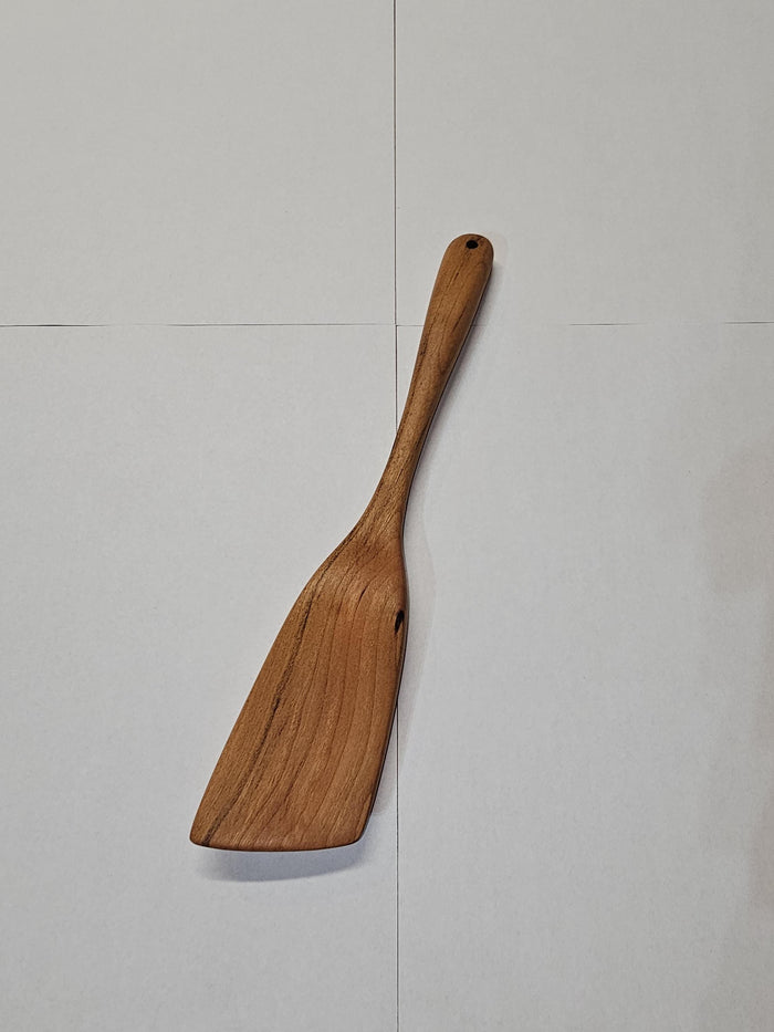small wooden angled spatula on white background